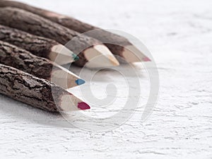 Close up macro shot of color pencils made of nature wood on pain