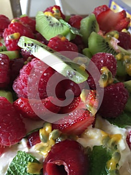 Close up macro shot of fruit salad strawberries and kiwi fruit