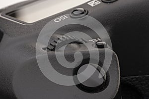 Close-up macro shot of a modern digital SLR camera. Detailed photo of black camera body with a classic wide aperture portrait lens