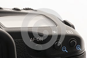 Close-up macro shot of a modern digital SLR camera. Detailed photo of black camera body with a classic wide aperture portrait lens