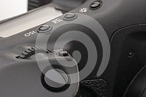 Close-up macro shot of a modern digital SLR camera. Detailed photo of black camera body with a classic wide aperture portrait lens