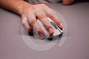 Close-up Macro Shot: Person& x27;s Hand Using Wireless Computer Mouse, Scrolls through Apps and Websites with a Wheel and Clicks
