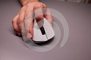 Close-up Macro Shot: Person& x27;s Hand Using Wireless Computer Mouse, Scrolls through Apps and Websites with a Wheel and Clicks