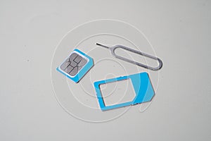 Close up macro of SIM card and SIM tray ejector tool