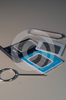 Close up macro of SIM card and SIM tray ejector tool