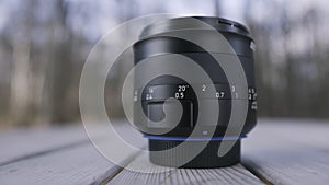 Close up macro view of camera lens on blurred natural background. Action. Professional camera lens detail, art and