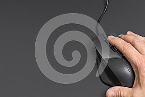 Close up macro view of male hand on computer mouse.