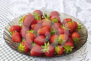 Close up macro view of plate with red ripe strawberrys isolated