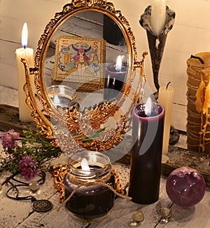 Close up with magic mirror and black candles