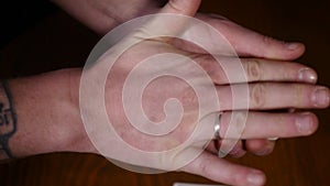 Close-up of a magician`s hands performing card tricks, making fan out cards on black background