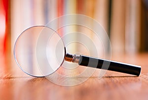 Close up Magnifying Glass Leaning on Wooden Table