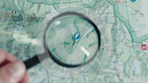 A close up of the magnifying glass used to look at the map. Looking for directions on the map when using a magnifying