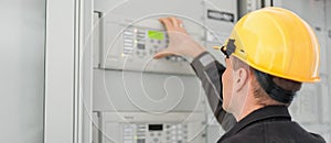 Close up of maintenance engineer testing voltage switchgear