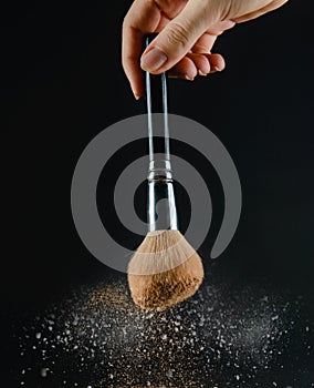 close up of a make up powder and a brush