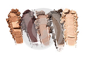 Close-up of make-up swatches. Smears of crushed gray, beige and brown eye shadow
