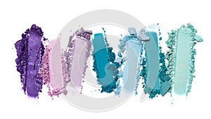 Close-up of make-up swatches. Smears of crushed turquoise and purple eye shadow