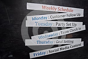 Close up making agenda weekly schedule on personal organizer. Business and entrepreneur concept. Isolated on blackboard