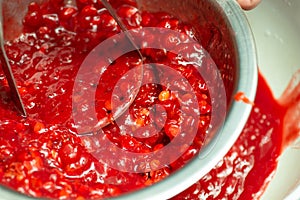 Close up of making jam from guelder rose berries