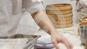 Close-up of making xiao long bao in the kitchen.