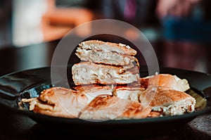 Close up of Malaysian well known food `Roti John` on a dark background.