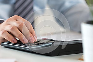 Close up of male accountant making calculations