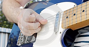 Close up Male bassist hands playing on guitar touching strings on rock performance man musician enjoying music. Slow