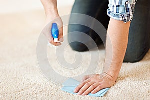 Close up of male cleaning stain on carpet