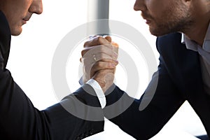 Close up of male competitors arm wrestle fighting at workplace