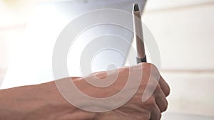 Close-up of a male designer draws on his laptop with help. graphic tablet and pen stylus