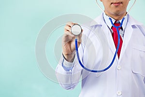 Close-up of male doctor with arms folded having stethoscope on his neck isolated on white background.