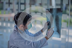 Close up of male doctor holding x-ray.