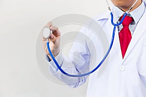 Close-up of male doctor using stethoscope and focusing on stethoscope.