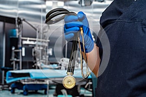 close up of male doctor wear dark blue uniform, stethoscope and gloves in emergency room