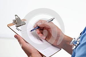 Close up of male doctor writing prescription paper