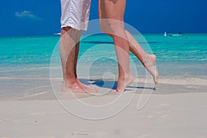 Close up male and female feet on white sand