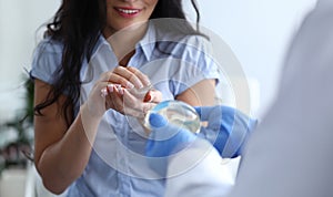 Close-up of male and female hands holding breast silicone implants