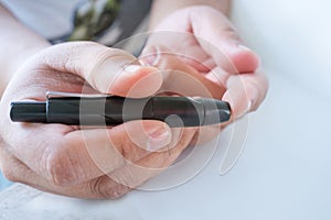 Close up of male finger patient pricking his finger to draw a d photo