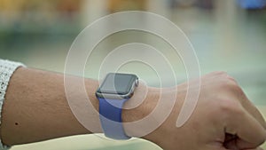 Close up of male finger swiping to the left on smartwatch