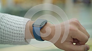 Close up of male finger tapping on smartwatch