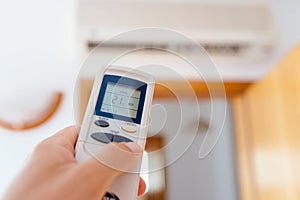 Close up on male hand adjusting home air condition