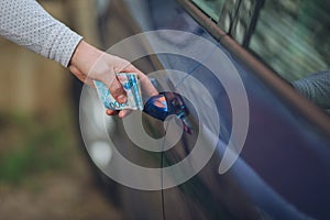 Close up of a male hand opening a car door.