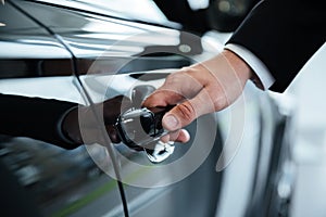 Close up of a male hand opening a car door