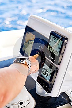 Close up hand pointing on navigation devices in catamaran deck, adventure recreational sport, yachting concept photo