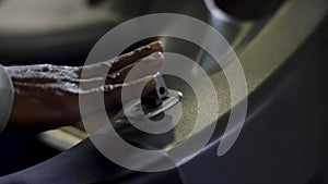 Close up of a male hand pulling the lever of a slot machine. Man playing a slot machine, casino concept.