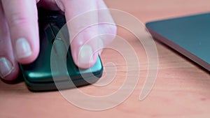 Close-up male hand using computer mouse. Work at home or in office