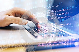 Close up of male hand using laptop keyboard with abstract html code on creative city background. Coding and programming concept.