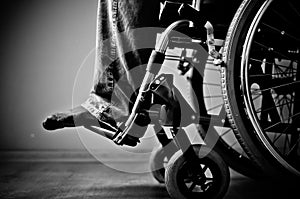 Close-up of male hand on wheel of wheelchair