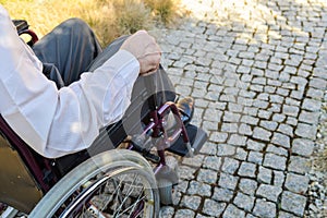 Close-up of male hand on wheel of wheelchair photo