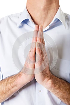 Close up on male hands clenched to pray