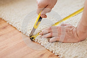 Close up of male hands cutting carpet